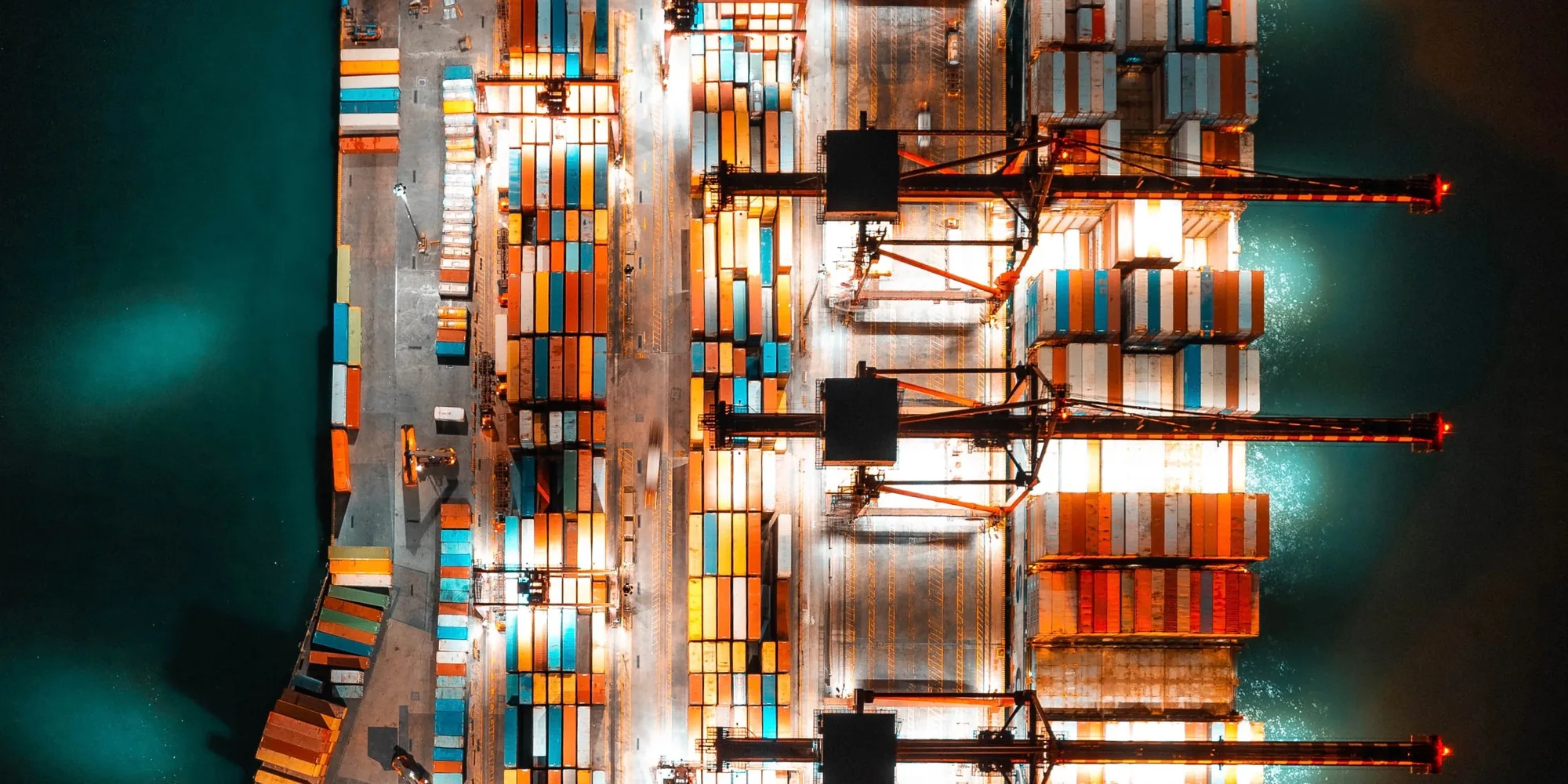 An aerial view of a container terminal lit at night